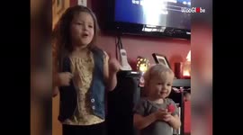 'Melodious little girl 'helps out' her sister with singing rehearsal'