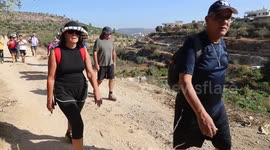 Israeli settlers participate in a march in the village of Hussan, near Bethlehem, in the West Bank