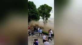 Tourists scream and flee as huge tidal bore slams into shore in eastern China