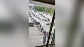 Hundreds of students line up to enter university library in central China