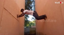 'Jackie Chan fan climbs a wall without a safety harness '