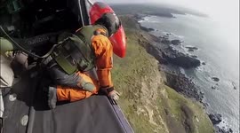 Search and Rescue Royal Navy helicopter into land on the cliff following a rescue training exercise