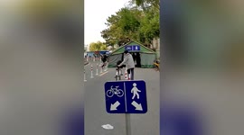 Man hilariously misunderstands sign and pushes bike in one lane and walks in the other