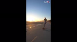 'Skater falls down while practicing a longboard dance step on the beach
'