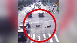 Distracted scooter rider looking at phone is knocked over by oncoming car in China