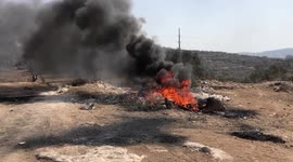 Palestinian protesters clash with Israeli troops during a demonstration against settlements in the village of Beita