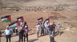 Palestinian protesters clash with Israeli troops during a demonstration against settlements in the village of Beit Dajan