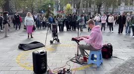 Busker man entertains Leicester Square crowd with Sweet Caroline