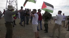 Protesters confront Israeli soldiers during a demonstration by Palestinian land-owners against confiscation of lands by Israel