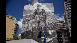 The process of artist creating a mural from ashes in São Paulo, Brazil