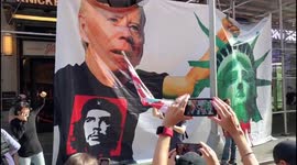 Giant artwork shows Biden holding decapitated head of Statue of Liberty during the 'Times Square Rally for Freedom'