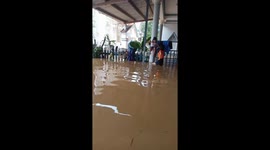 Children with dinghies seek refuge as house is inundated by muddy water in Vietnam