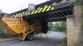 Skip lorry crashes into railway bridge in Cheltenham, Gloucestershire