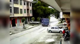 Speeding truck narrowly avoids girl running across road in southern China
