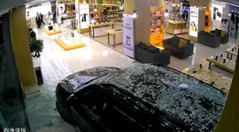 Car smashes into phone shop in China as motorist presses accelerator by mistake
