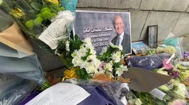 Flower tributes for Sir David Amess outside Houses of Parliament in London