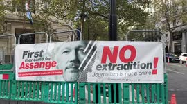 A group of people protest in front of Australia House urging UK to free Julian Assange