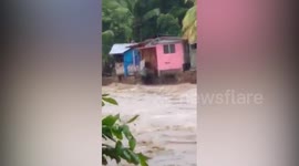 River swallows up homes after heavy rain in the Philippines