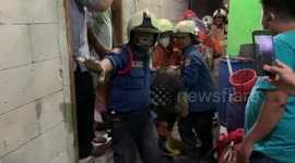Firefighters rescue mother and  child buried under collapsed building in Jakarta