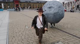 Father and son recreate famous boulder scene from 'Raiders of the Lost Ark' at London's MCM Comic Con on Sunday