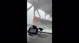 Truck left overturned on bridge due to powerful winds in California