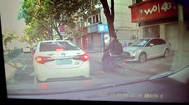 Passing scooter rider throws bottle back into car after driver dashes it onto street