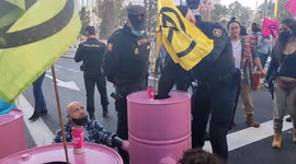 Police attempt to disperse Extinction Rebellion protesters blocking roads in Madrid