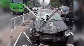 Steel bars impale car after tired motorist drives vehicle through barriers in middle of road in China