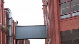 Bizarre moment pro-Palestine activist in Manchester traverses on defense company roof and falls THROUGH