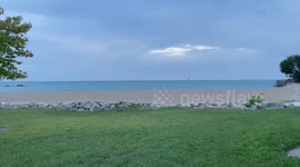 Kenosha wisconsin Beach on Lake Michigan as the sun sets on a cloudy summer day