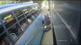 Lucky escape for couple with baby when motor scooter is SANDWICHED between two buses