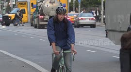 Car and cyclist traffic building on Toronto streets as in person work and school resumes with many people still riding bikes to and from the office