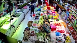 Astonishing moment 'cruel' supermarket owner kicks escaped fish back into tank