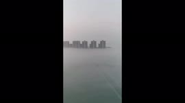 High-rise buildings poke out from thick fog shrouding city in China