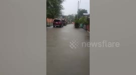 Knee-deep water floods roads in the Philippines due to monsoon