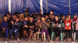 Palestinian children attend a circus performance in Beit Hanoun
