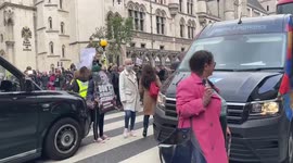 Protesters in front of Royal Courts of Justice block main road