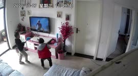 KERPOW! Boy smashes TV with brush as he tries to help on-screen superhero