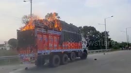 Oblivious driver drives burning truck amid road in central India