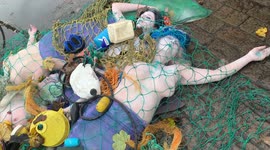 Activists dress as dead mermaids against bottom trawling outside COP 26 venue
