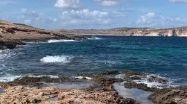 Waves crashing on the rocks at Triq Dahlet Ix-Xmajjar, Il-Mellieħa, Malta by the Coral Lagoon