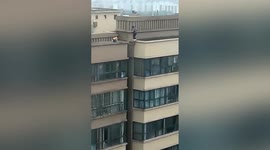 Terrifying scene as young boys spotted playing on edge of multi-storey building roof in China