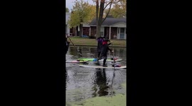 Women dressed as witches switch brooms for paddleboards on Halloween ride down US river
