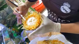 Watch this artist intricately carve beautiful floral pattern into a papaya