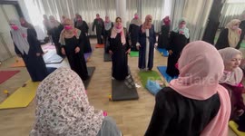 Palestinian female cancer patients practice yoga during a therapy session