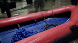 Firefighters evacuate residents trapped by floodwater that has submerged Jakarta