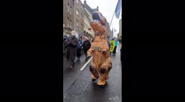 Protester in T-Rex suit calls for climate justice during COP26 in Scotland