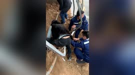Chinese workers rescue trapped motorist after truck transporting soil tips over onto car