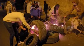 Palestinian protesters set tyres on fire during clashes with Israeli troops