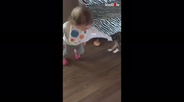 Adorable baby and naughty dog play together at home
